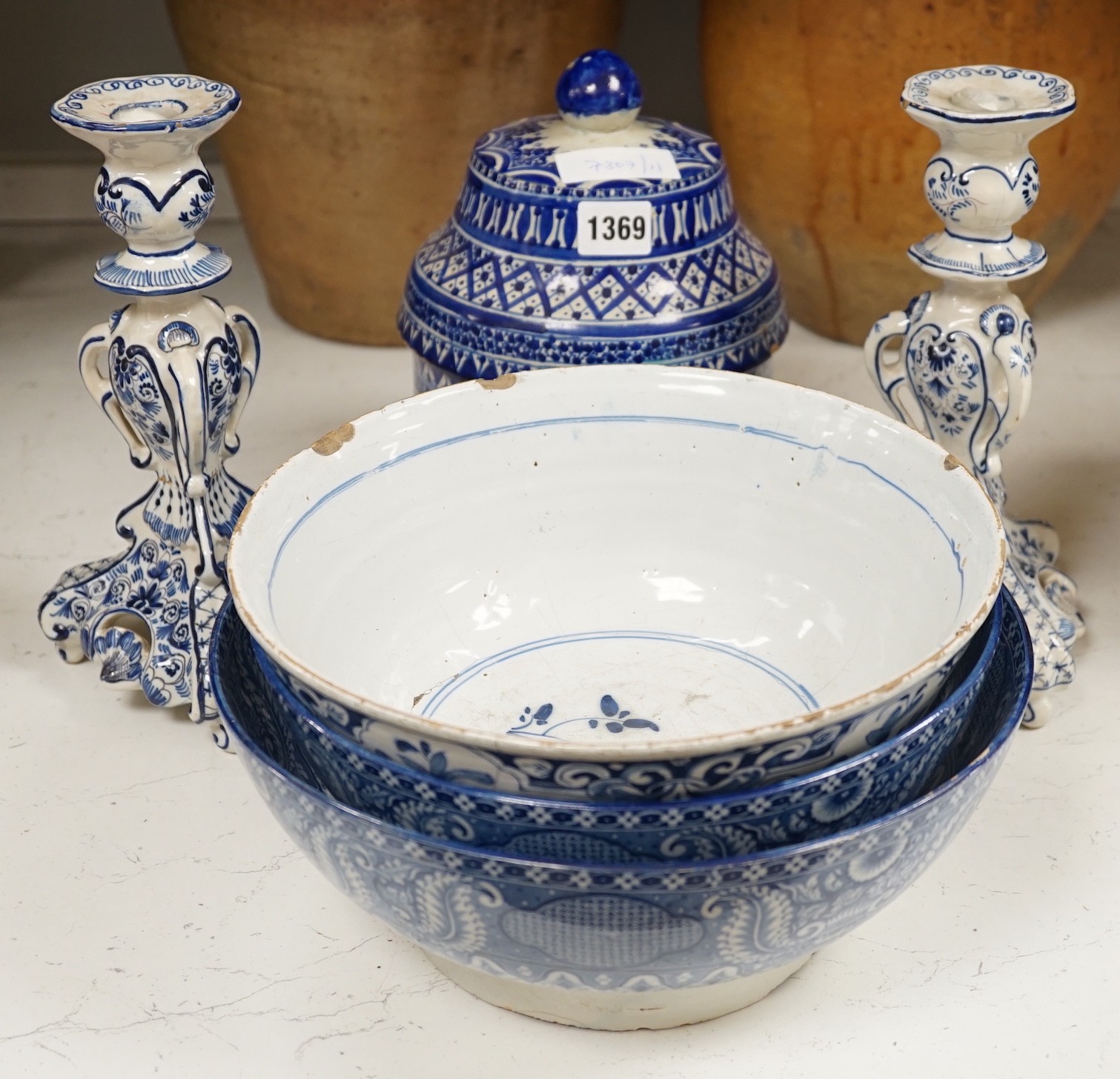 A pair of Delft blue and white candlesticks together with an 18th century Delft bowl, a Moroccan pottery jar with cover, and two pearlware bowls